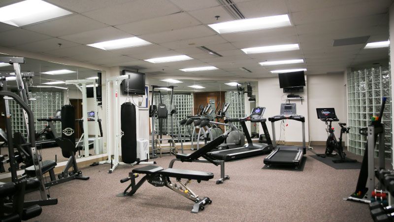 HeinOnline building gym with treadmill, Peloton, punching bag, and more, within luxury office space for rent.