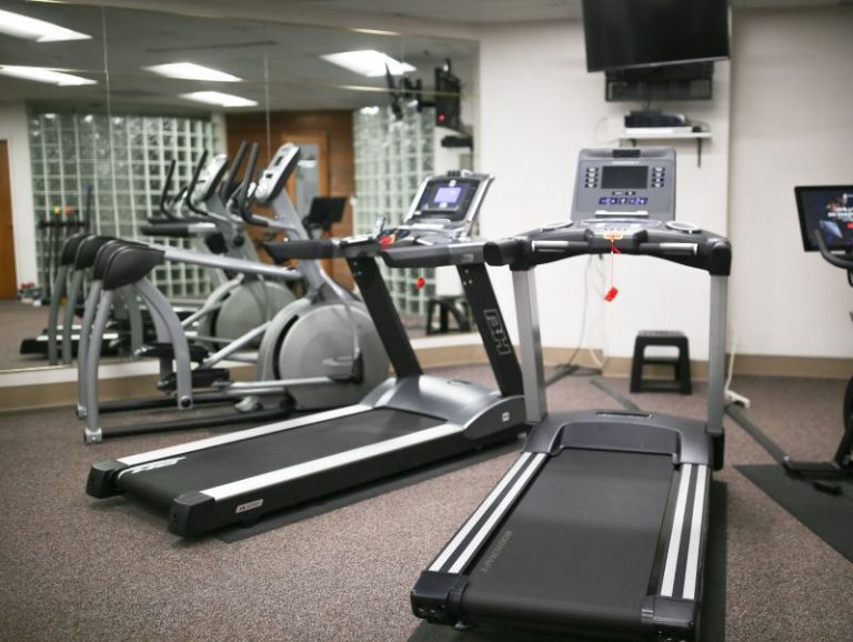 Picture of Tredmill and Elliptical amenities in a gym.